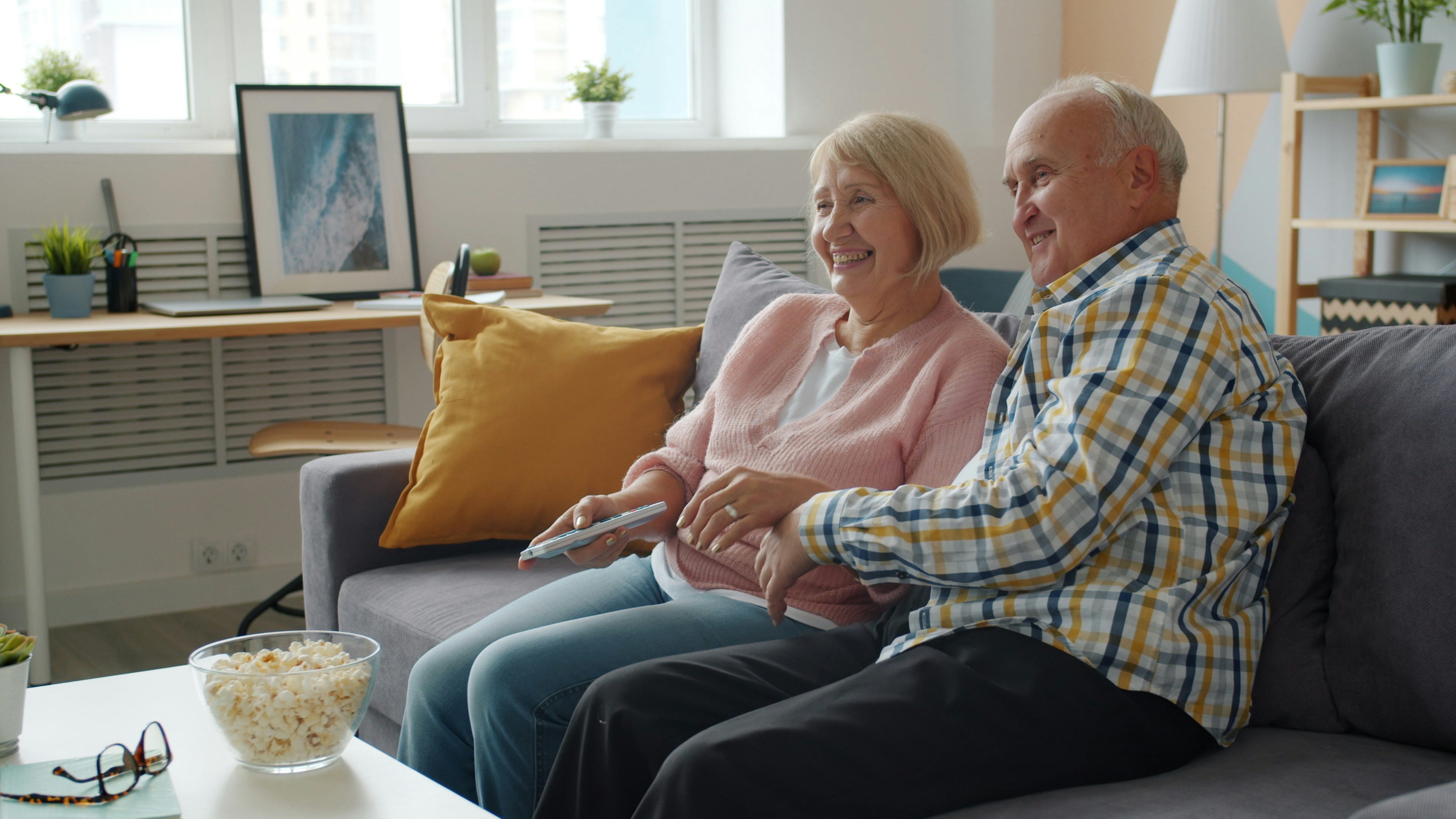 Elderly couple relaxing comfortably at home