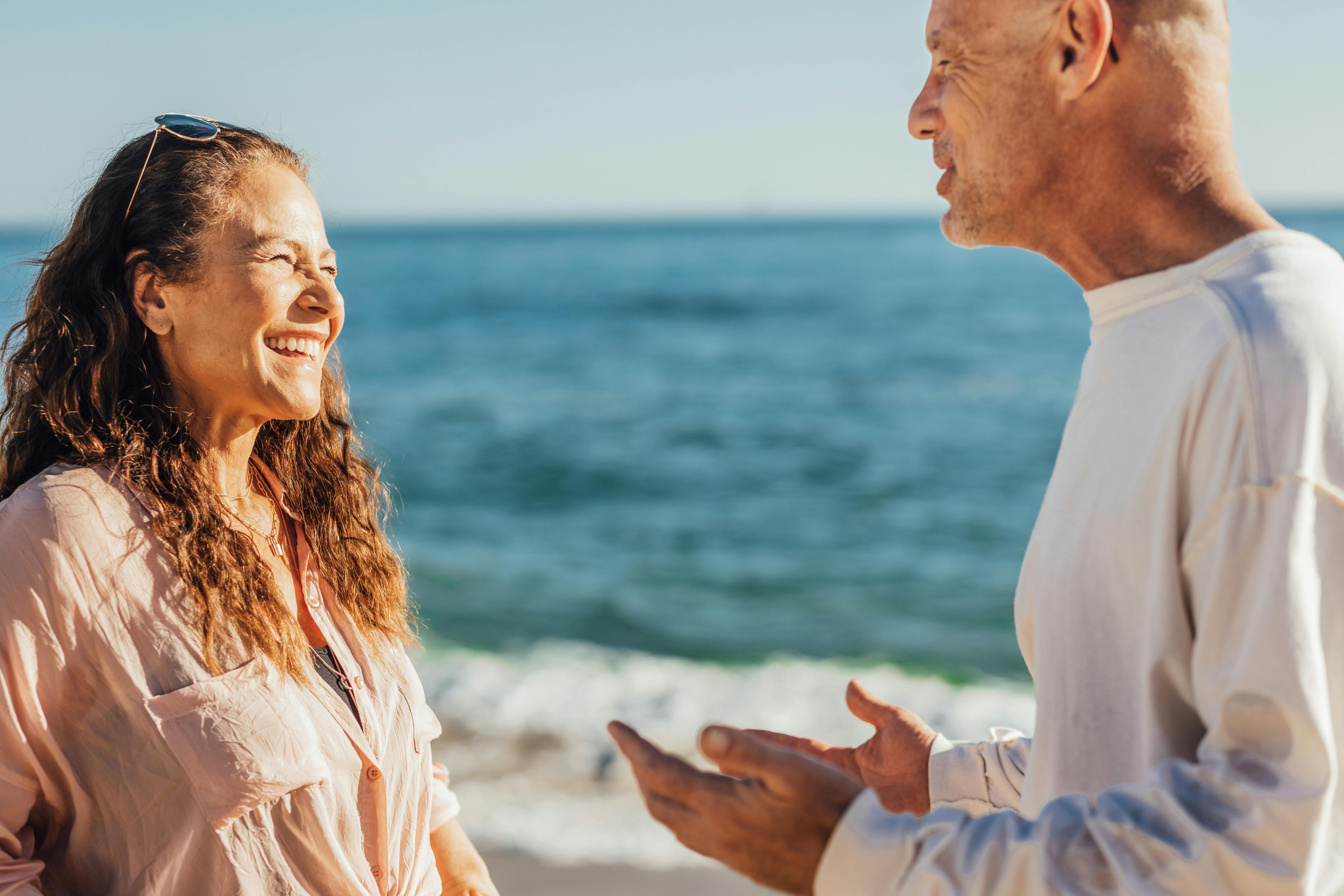 Happy elderly couple having a warm, joyful conversation outdoors